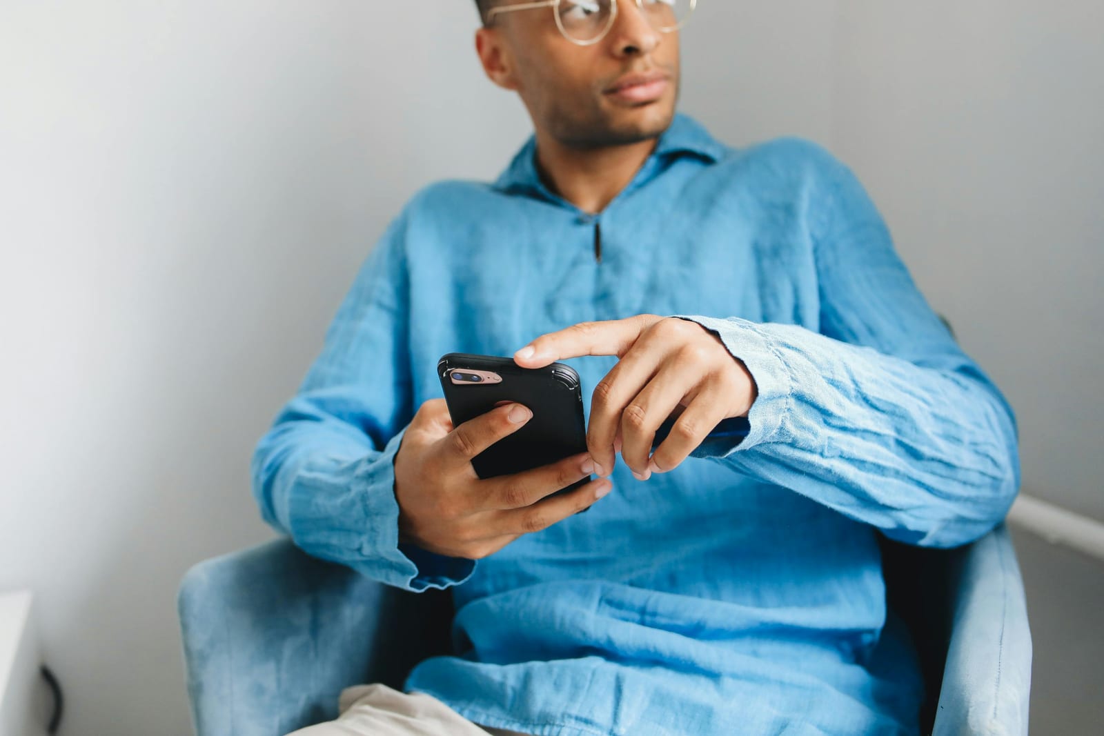 A man living abroad checks his phone to meet new people