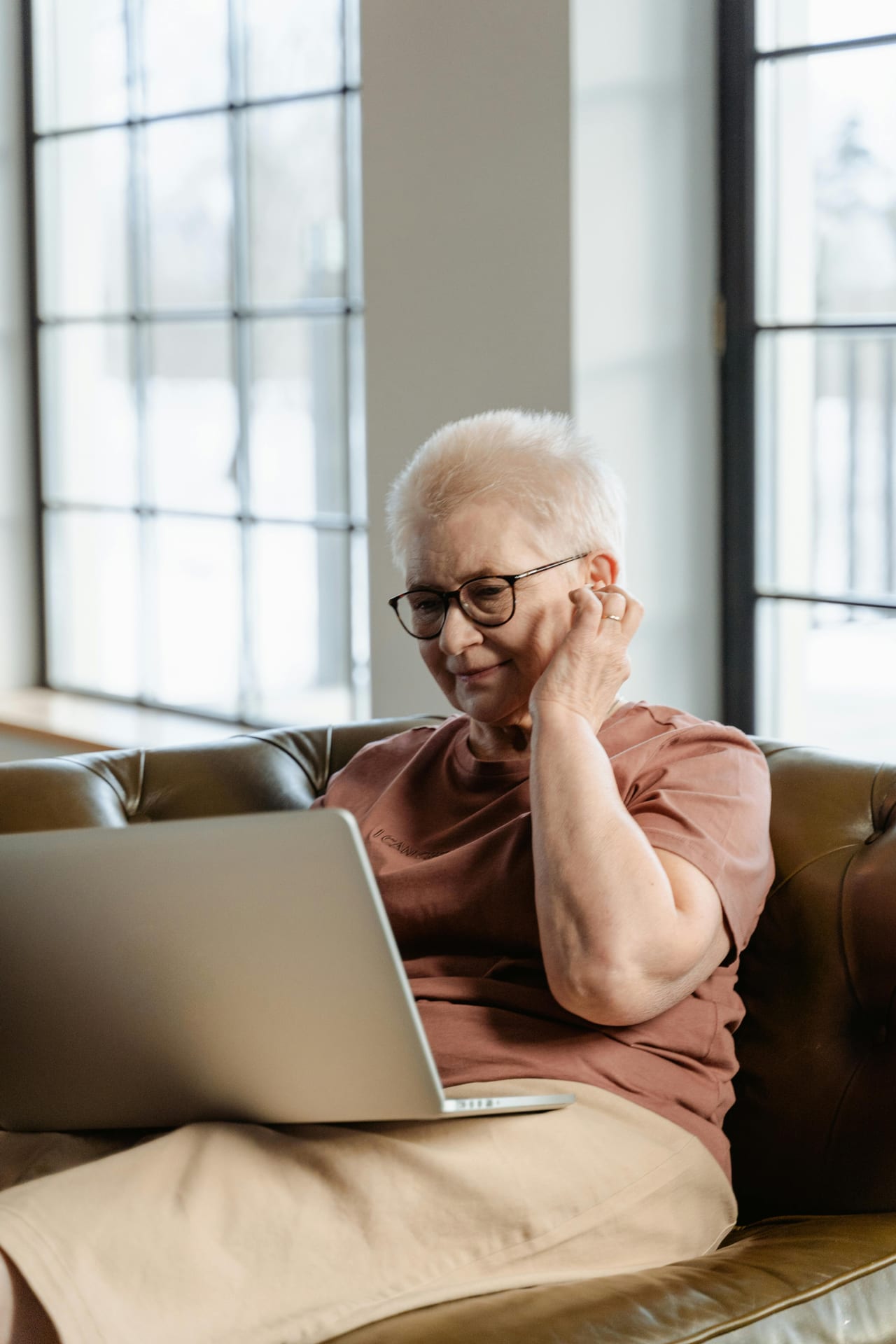 A 56 year old woman talks from her computer while searching for work